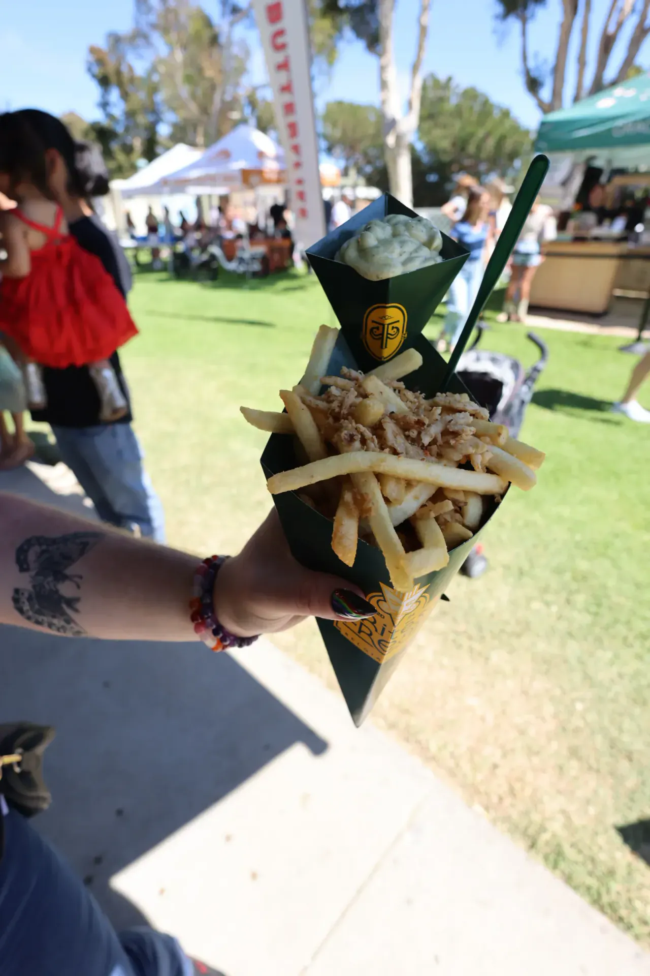 A cone loaded with shredded meat, served with a side of aioli