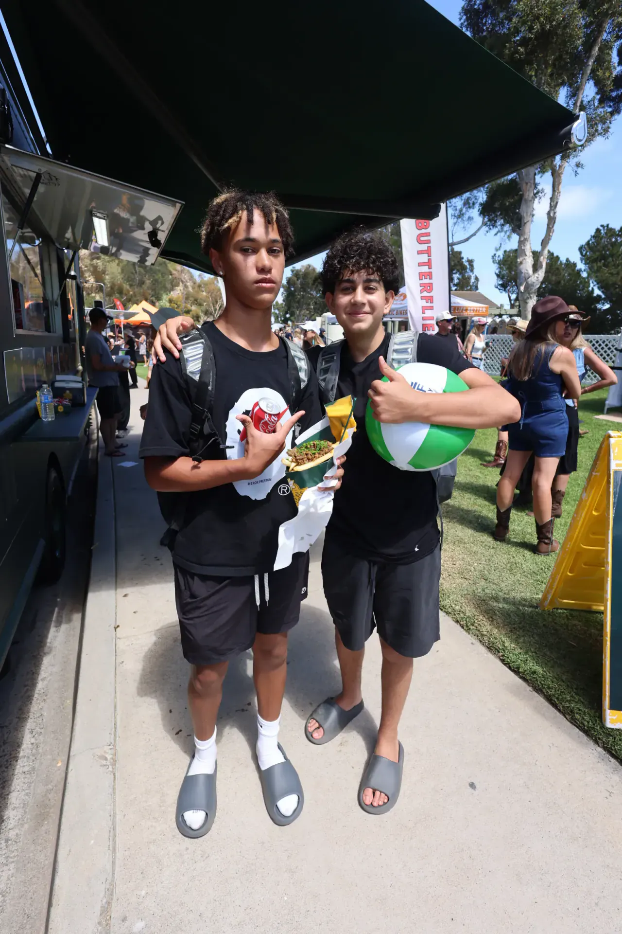 Guests with their cones beside the truck at a sunny festival