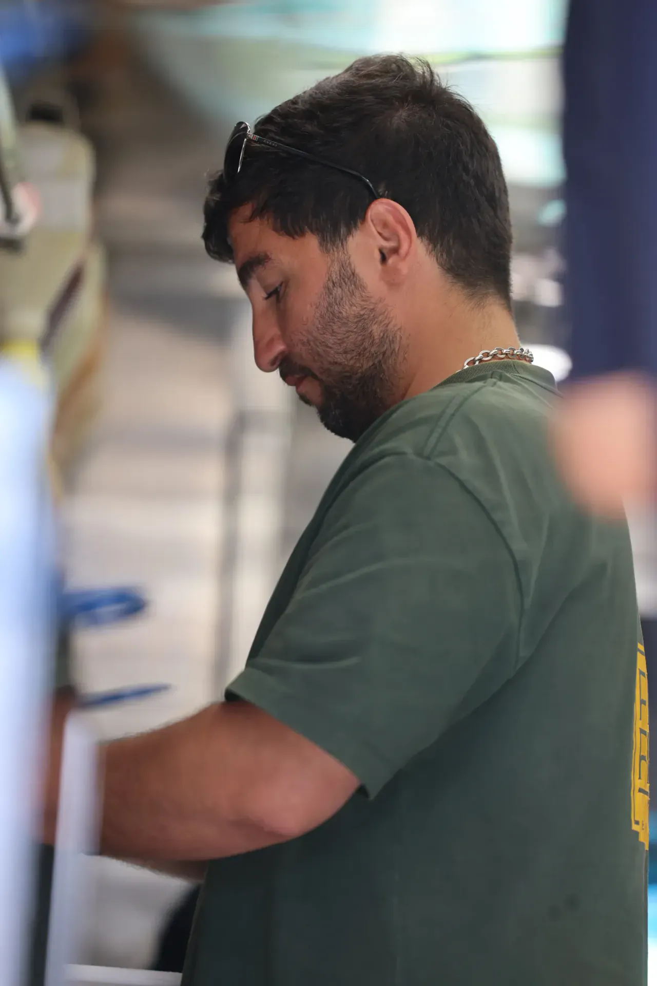 A Freak at work behind the counter in the branded green tee